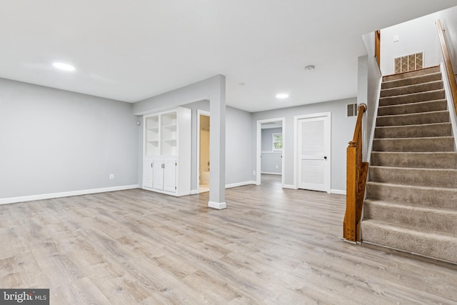7702 Ousley Pl, Alexandria, VA 22315 - basement featuring stairway, light wood-style flooring, and recessed lighting