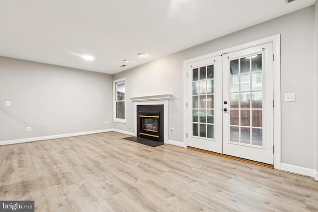 7702 Ousley Pl, Alexandria, VA 22315 - unfurnished living room featuring french doors, wood finished floors, a fireplace with flush hearth, and recessed lighting
