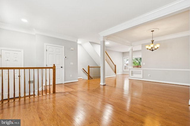 7702 Ousley Pl, Alexandria, VA 22315 - spare room with crown molding, wood finished floors, a chandelier, recessed lighting, and decorative columns