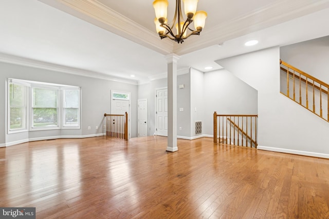 7702 Ousley Pl, Alexandria, VA 22315 - unfurnished living room featuring crown molding, ornate columns, a chandelier, hardwood / wood-style floors, and recessed lighting
