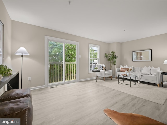 living area with wood finished floors and baseboards