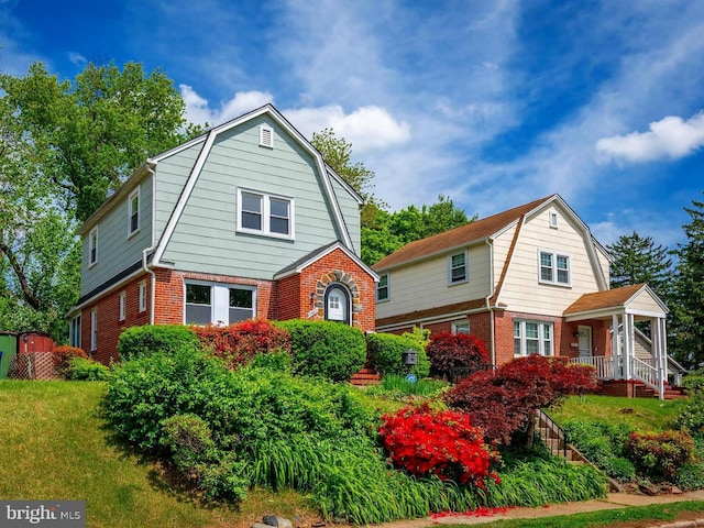 3902 Biddison Ln, Baltimore, MD 21206 - colonial inspired home with a gambrel roof, brick siding, a porch, and a front lawn