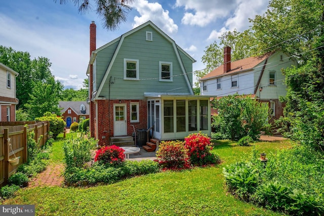 3902 Biddison Ln, Baltimore, MD 21206 - back of property featuring entry steps, a gambrel roof, brick siding, a sunroom, and a chimney