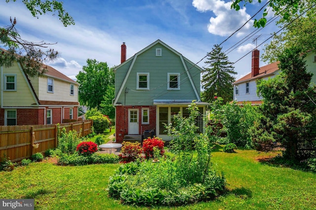 3902 Biddison Ln, Baltimore, MD 21206 - back of property with a gambrel roof, a chimney, brick siding, and a sunroom