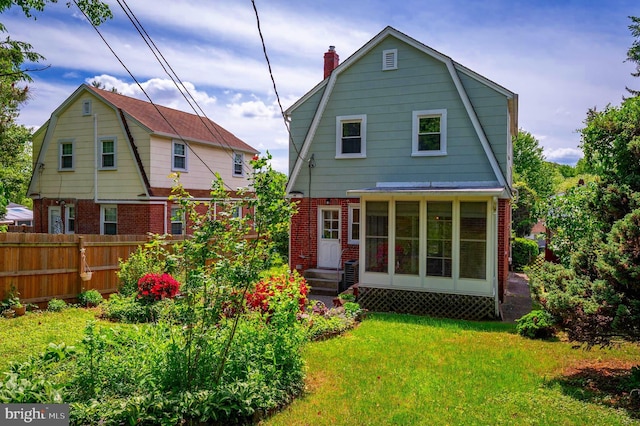 3902 Biddison Ln, Baltimore, MD 21206 - rear view of property featuring a gambrel roof, brick siding, and a chimney