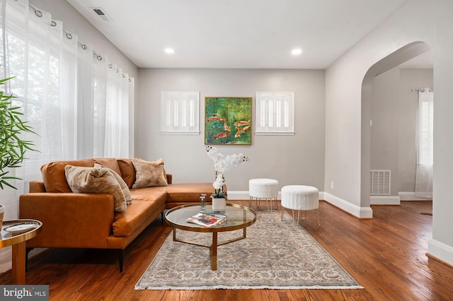 3902 Biddison Ln, Baltimore, MD 21206 - living area with arched walkways, wood finished floors, baseboards, plenty of natural light, and recessed lighting