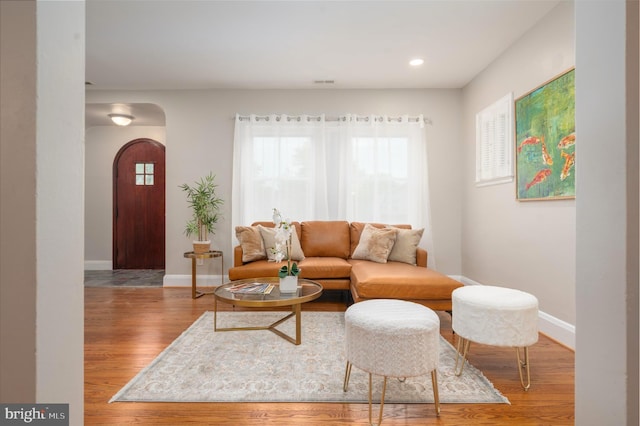 3902 Biddison Ln, Baltimore, MD 21206 - living area with arched walkways, baseboards, wood finished floors, and recessed lighting