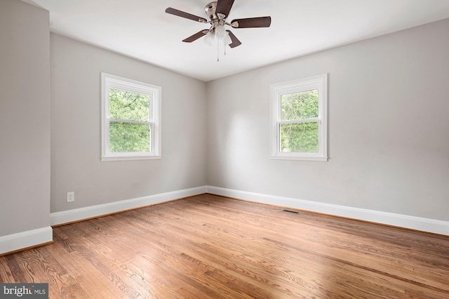 3902 Biddison Ln, Baltimore, MD 21206 - empty room with plenty of natural light, baseboards, wood finished floors, and ceiling fan