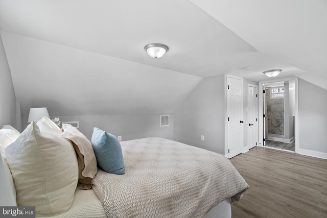 2704 Rueckert Ave, Baltimore, MD 21214 - bedroom with wood finished floors, lofted ceiling, baseboards, and ensuite bathroom