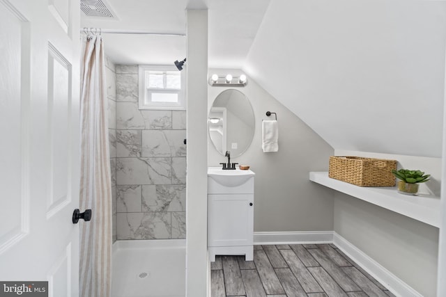 2704 Rueckert Ave, Baltimore, MD 21214 - bathroom featuring a stall shower, vanity, wood finished floors, and baseboards
