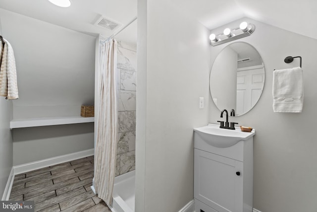 2704 Rueckert Ave, Baltimore, MD 21214 - bathroom featuring vanity, a stall shower, wood tiled floors, and baseboards