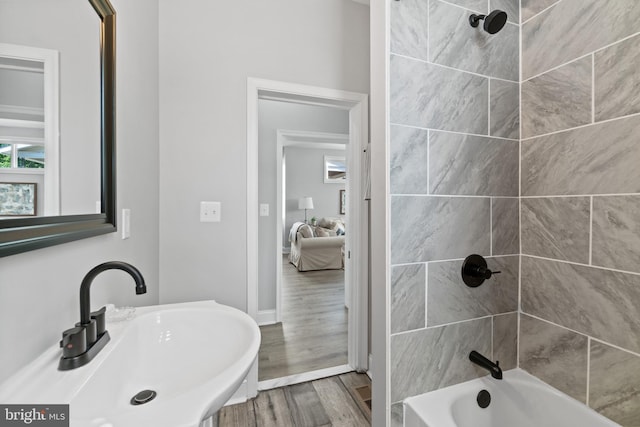 2704 Rueckert Ave, Baltimore, MD 21214 - bathroom featuring a sink, wood finished floors, bathtub / shower combination, and baseboards