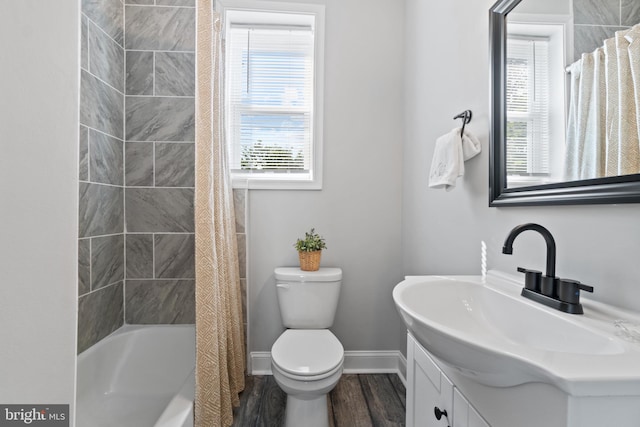 2704 Rueckert Ave, Baltimore, MD 21214 - full bath with toilet, wood finished floors, baseboards, vanity, and shower / bath combo