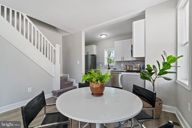 2704 Rueckert Ave, Baltimore, MD 21214 - dining room featuring baseboards, stairs, and wood finished floors