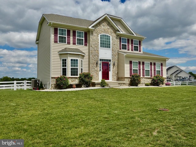 view of front of home with stone siding and central AC unit