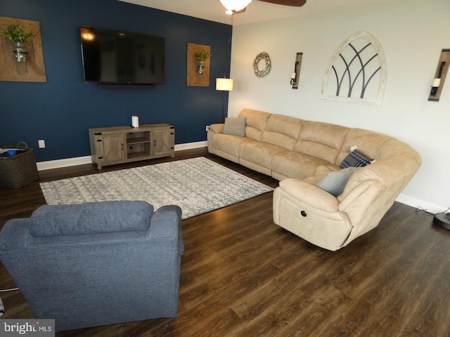 living room featuring wood finished floors, baseboards, and a ceiling fan