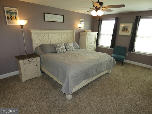 carpeted bedroom with baseboards, multiple windows, and ceiling fan