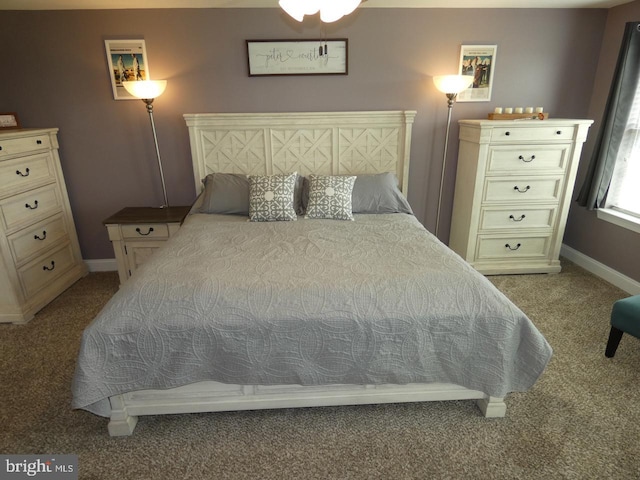 carpeted bedroom featuring baseboards