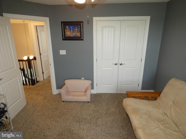 sitting room with carpet floors, a ceiling fan, and baseboards