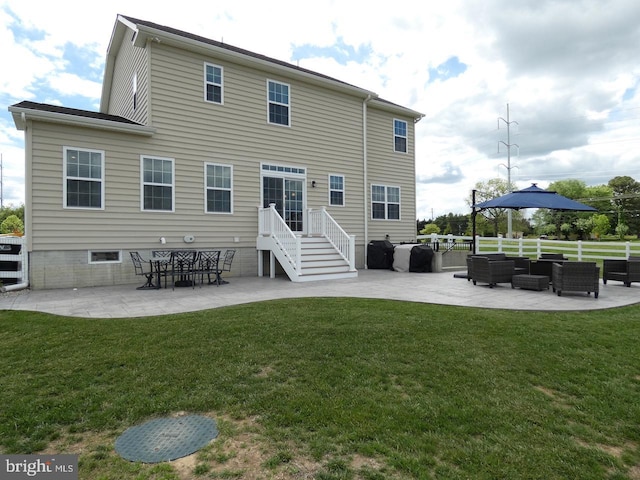 rear view of property with an outdoor hangout area and a patio