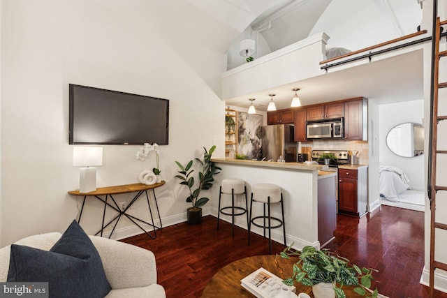 living room with dark wood-style floors, baseboards, and high vaulted ceiling