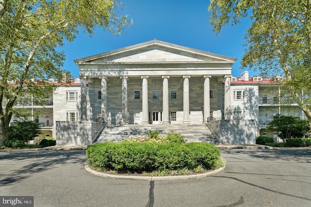 greek revival house with covered porch and stairway