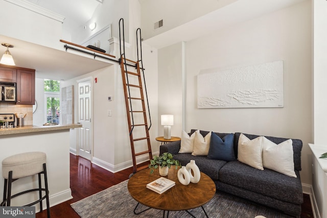 living room featuring dark wood-style flooring and baseboards