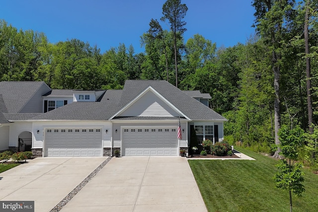 314 Tranquility Way, Middletown, DE 19709 - view of front facade featuring concrete driveway, an attached garage, a front yard, stone siding, and roof with shingles