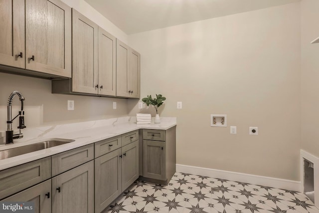 laundry room with electric dryer hookup, light floors, hookup for a washing machine, cabinet space, and baseboards