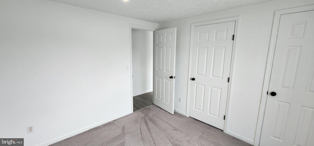 3371 Yost Ln Unit 201, Dumfries, VA 22026 - unfurnished bedroom with carpet floors, a textured ceiling, and baseboards