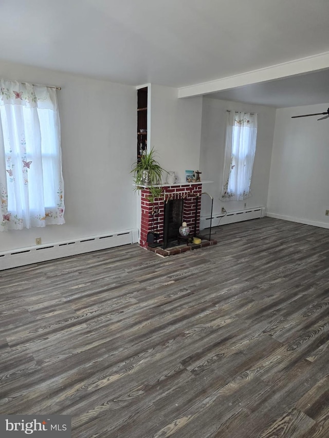 4527 Main St, Whitehall, PA 18052 - unfurnished living room with a baseboard heating unit, plenty of natural light, wood finished floors, and a brick fireplace