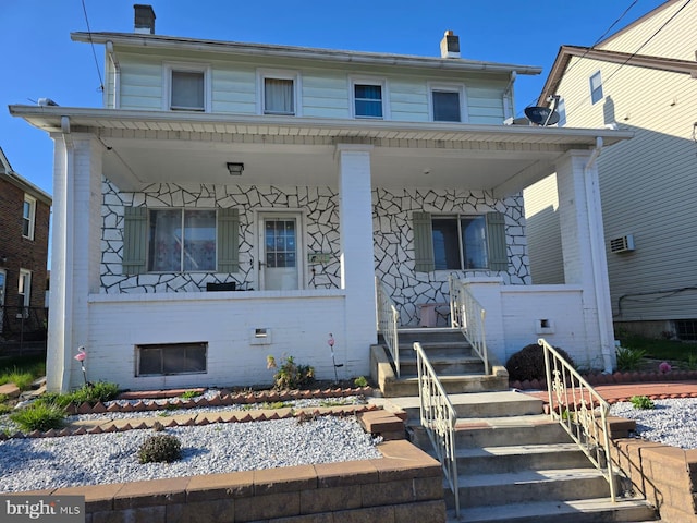 4527 Main St, Whitehall, PA 18052 - view of front of property with a porch, brick siding, and a chimney