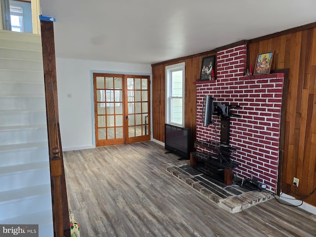 4527 Main St, Whitehall, PA 18052 - unfurnished living room with wood finished floors, baseboards, a wood stove, and wooden walls