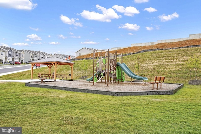 community jungle gym featuring a gazebo, a lawn, and a residential view