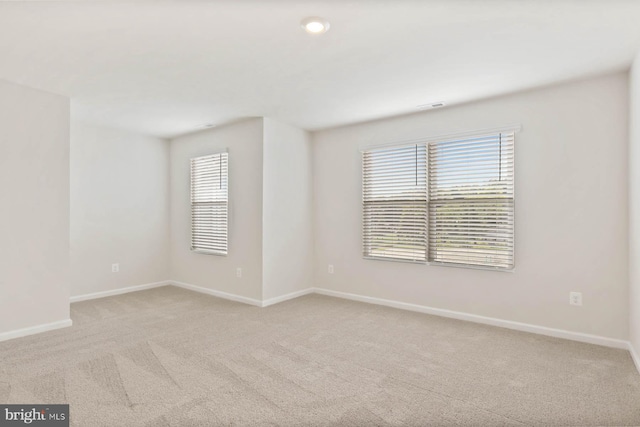 carpeted empty room with baseboards