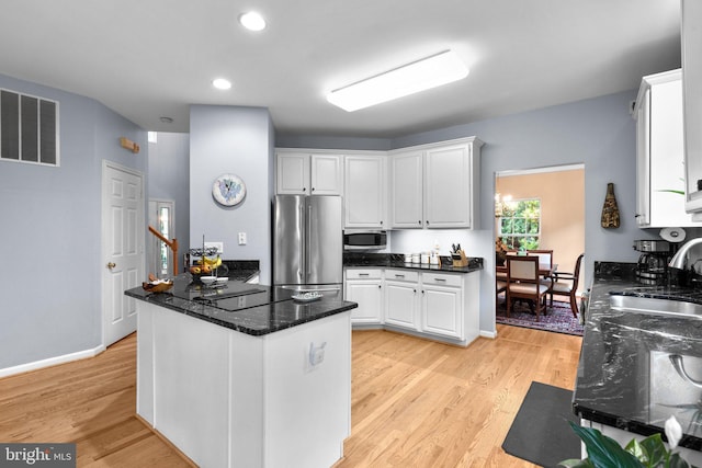 15066 Frederick Rd, Cooksville, MD 21723 - kitchen with stainless steel appliances, a sink, white cabinetry, light wood-type flooring, and recessed lighting