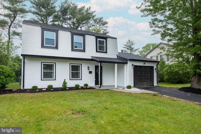 127 Toledo Ln, Willingboro, NJ 08046 - view of front of home with a garage, asphalt driveway, a front yard, and a porch