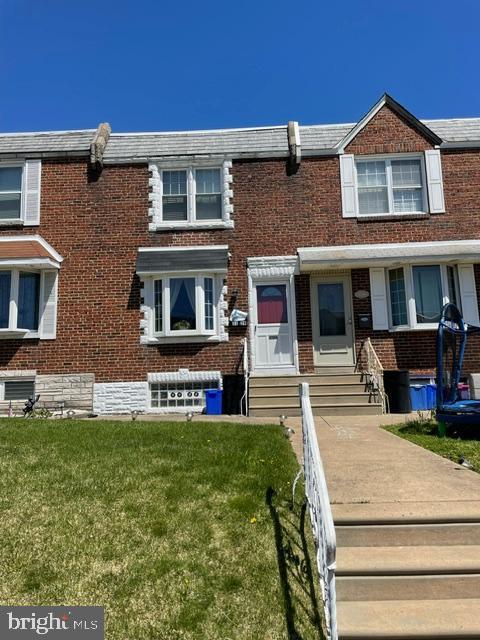 3339 Ashville St, Philadelphia, PA 19136 - multi unit property with brick siding, a front yard, and entry steps