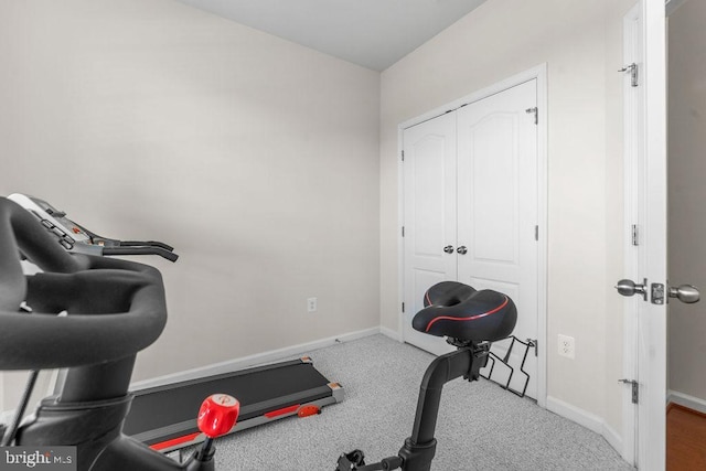 exercise area with carpet floors and baseboards