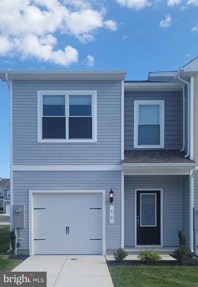 view of front of house featuring a garage, driveway, and covered porch