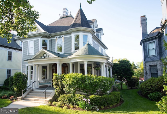 victorian home with covered porch and a front yard