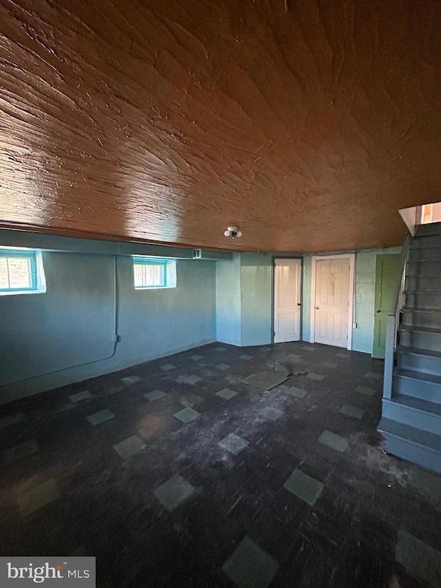 below grade area with wooden ceiling and stairway