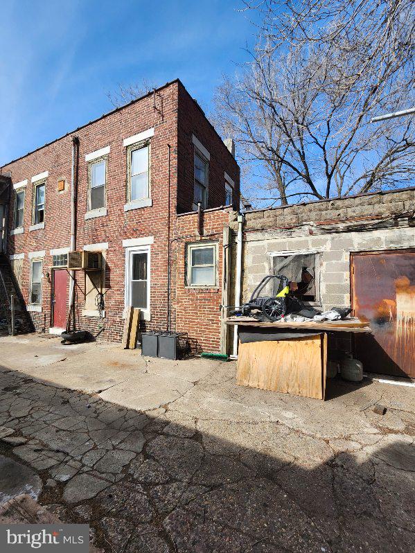 rear view of house with brick siding
