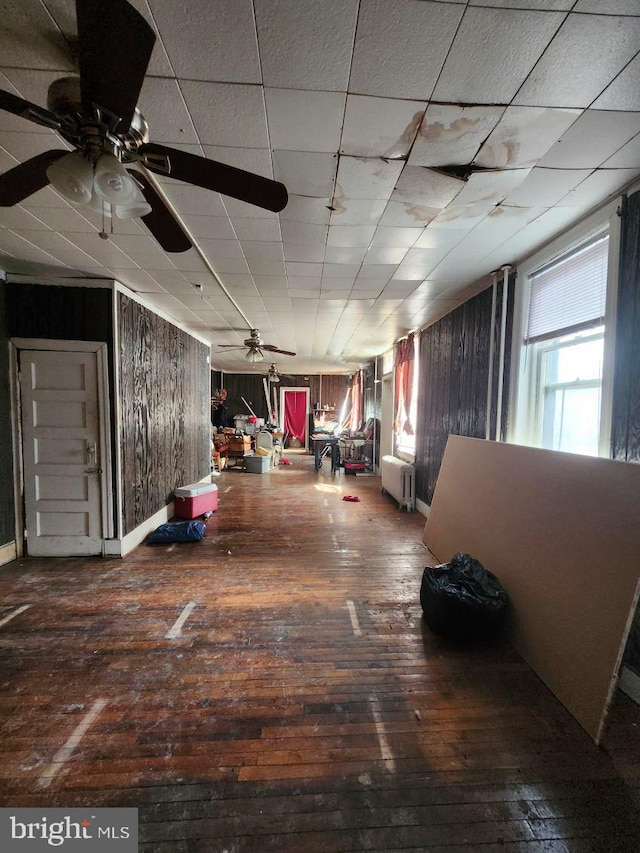 hall featuring hardwood / wood-style floors and wood walls
