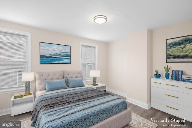 bedroom featuring baseboards and wood finished floors