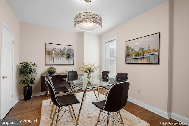 dining room featuring baseboards and wood finished floors