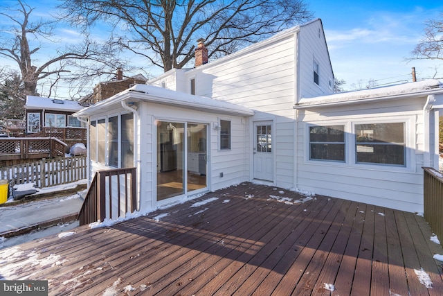 5721 Euclid St, Landover, MD 20785 - snow covered deck with a sunroom and fence