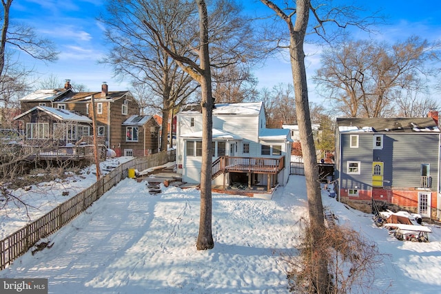 5721 Euclid St, Landover, MD 20785 - yard layered in snow with a deck, fence, and a residential view