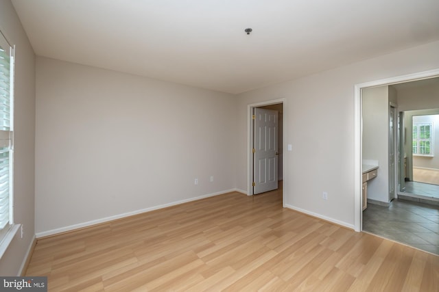 unfurnished bedroom featuring light wood finished floors and baseboards