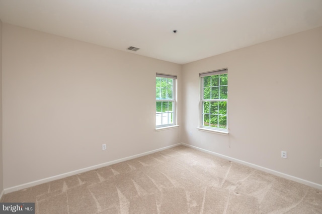 spare room with baseboards and carpet flooring